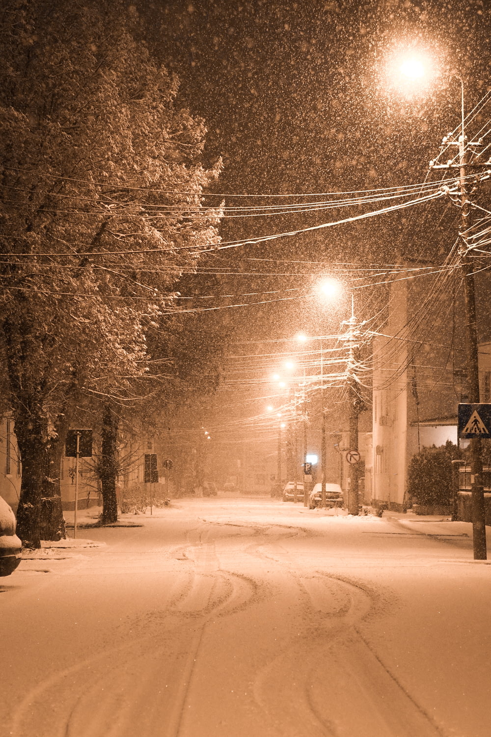a snowy street at night with street lights