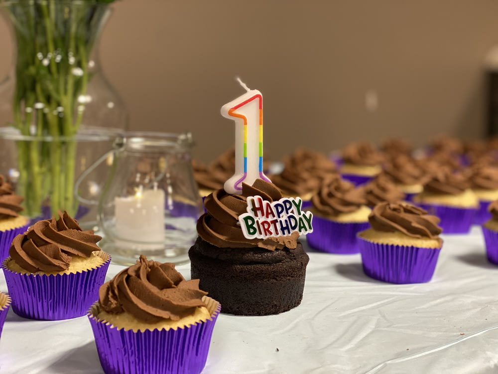 chocolate cupcake with pink and purple candles