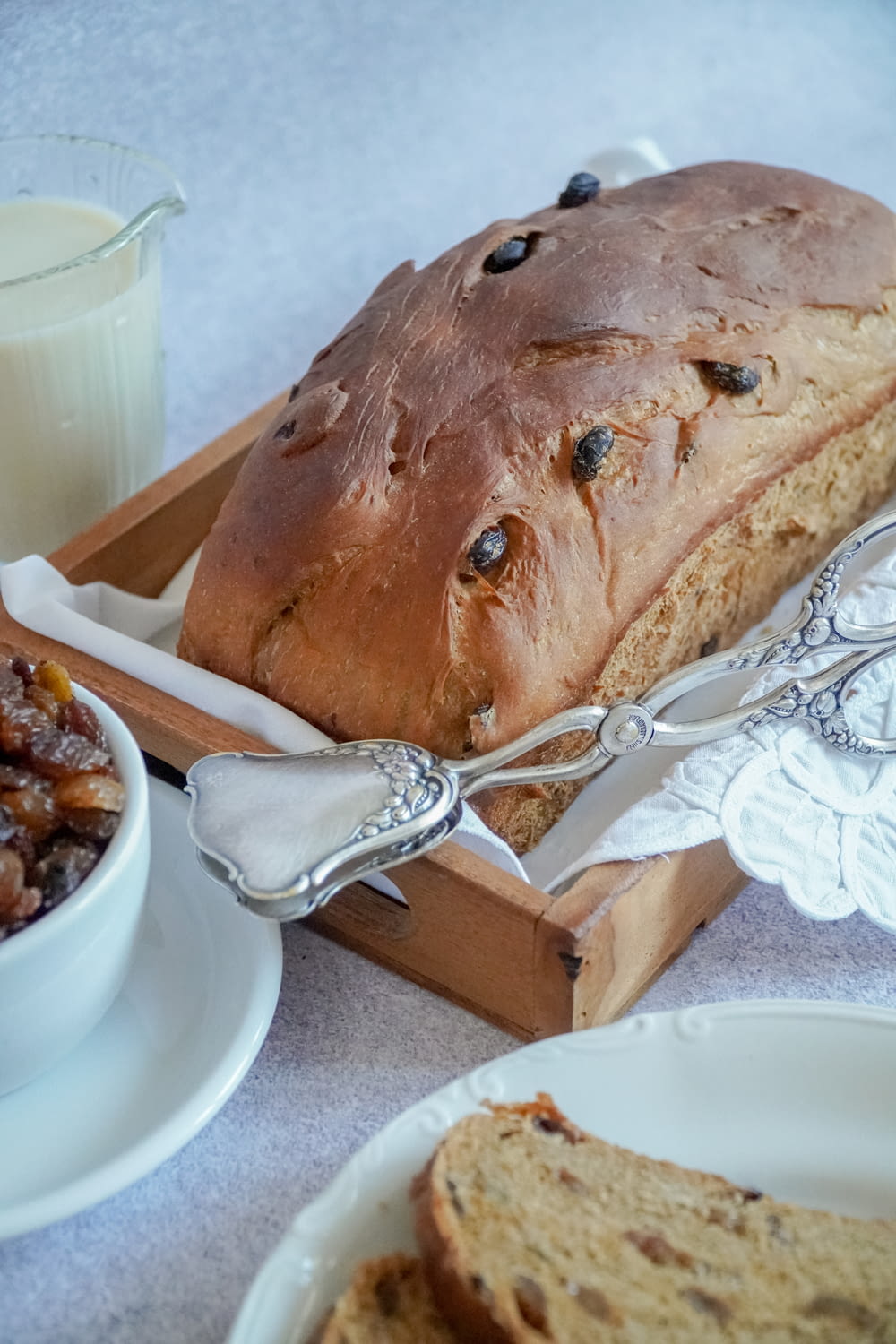 bread on white ceramic plate beside silver fork