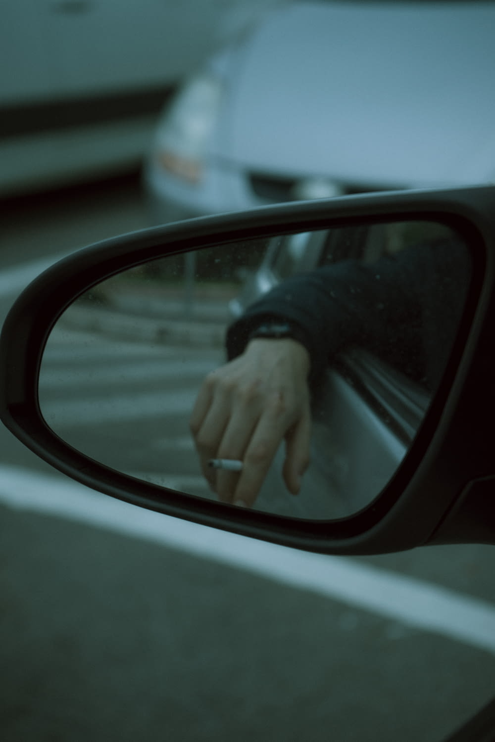 person holding car side mirror