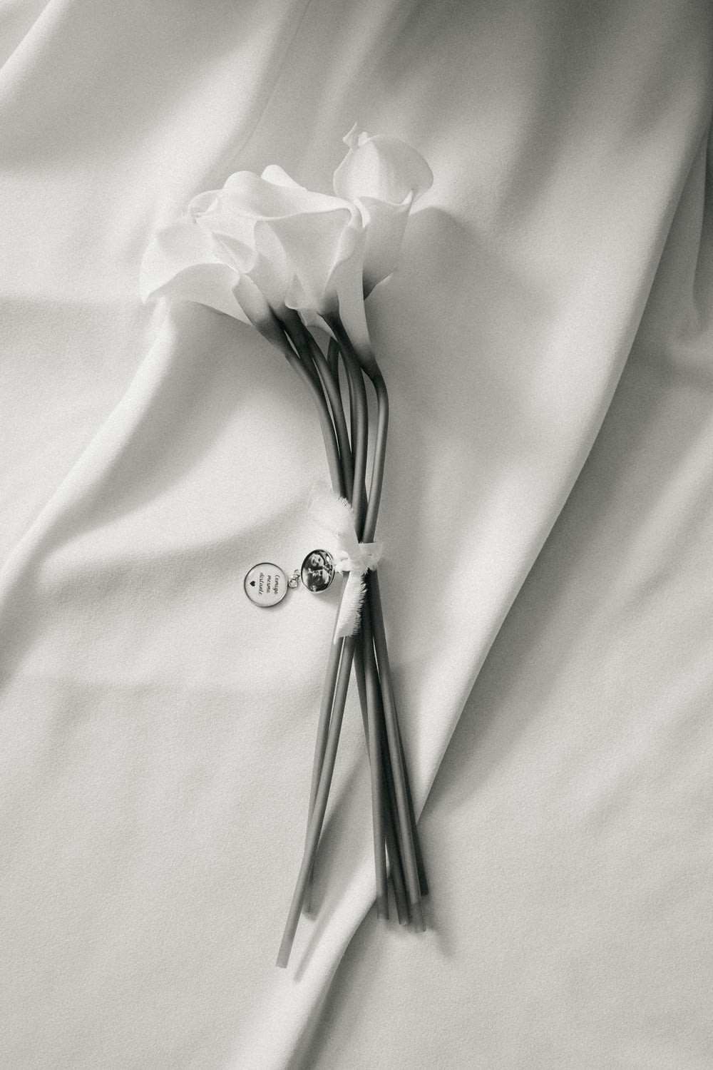 silver diamond studded ring on white textile