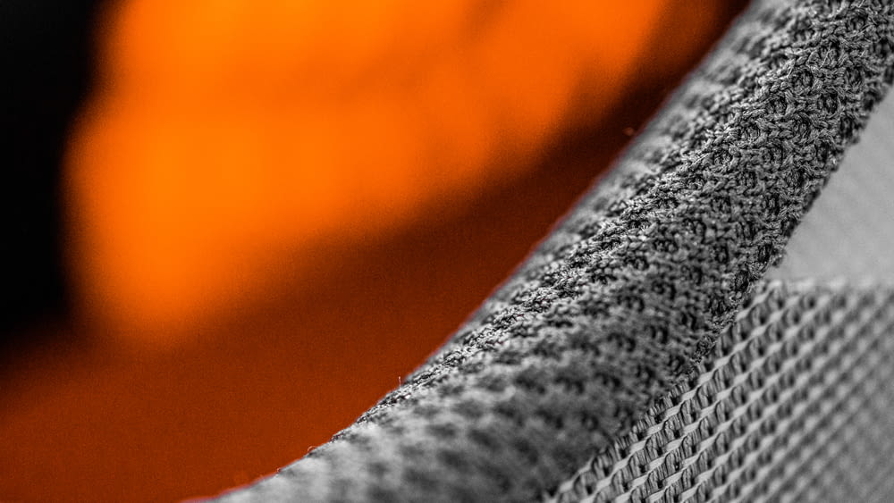gray textile on orange textile