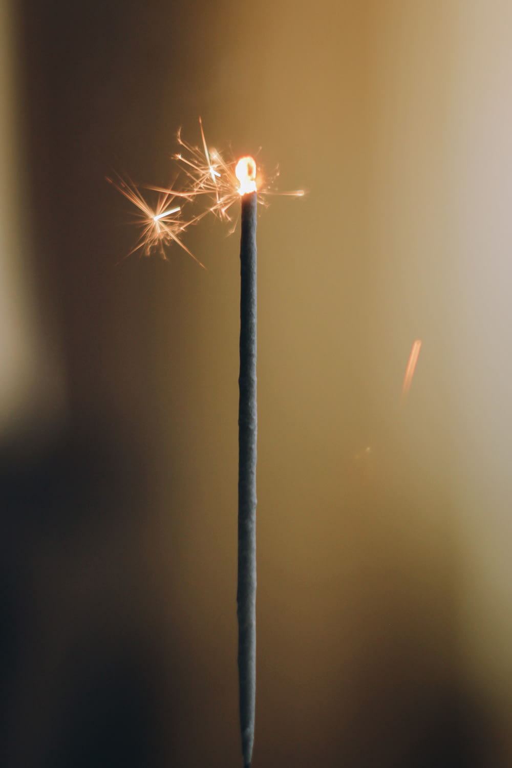 white lighted sparkler in close up photography