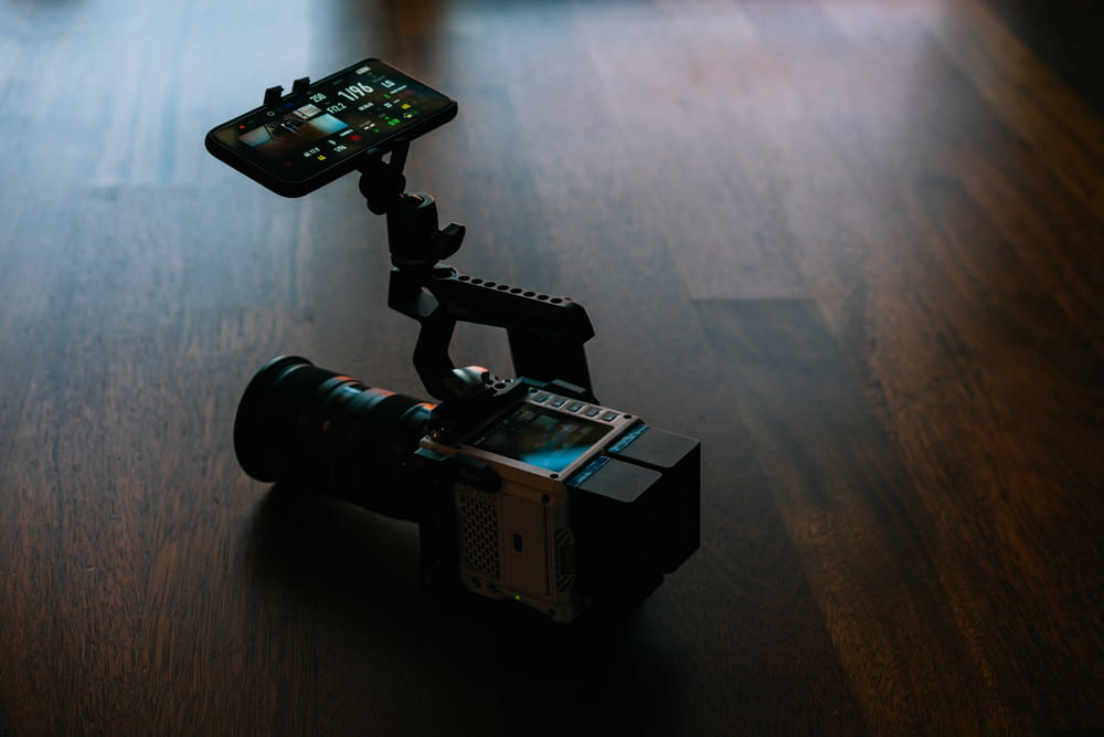 black and gray video camera on brown wooden table