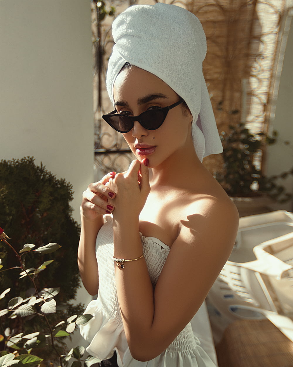 woman in white knit cap and black sunglasses