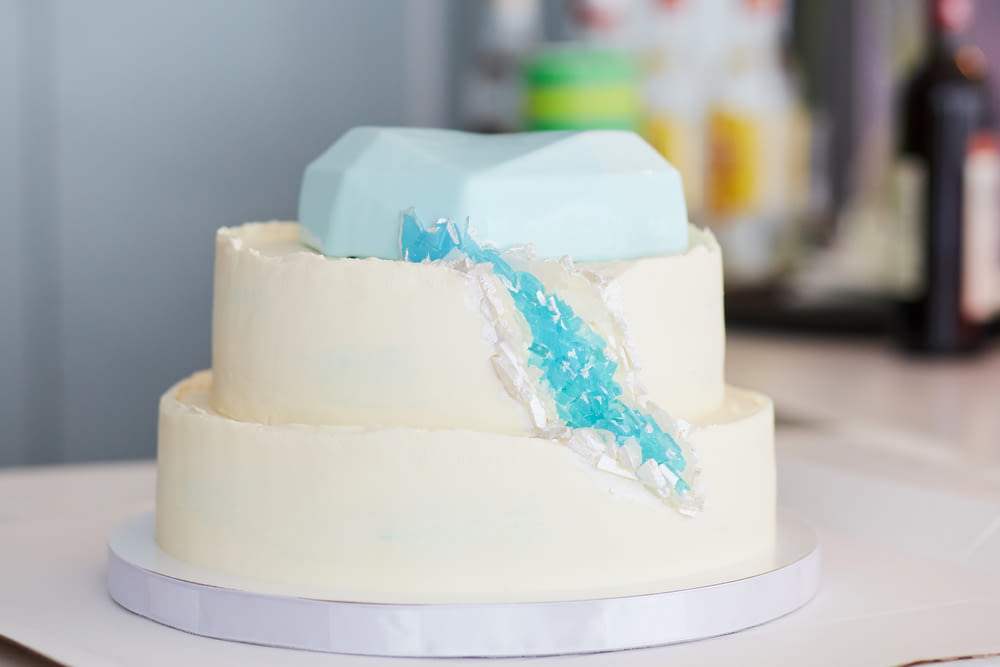 white and blue cake on white table