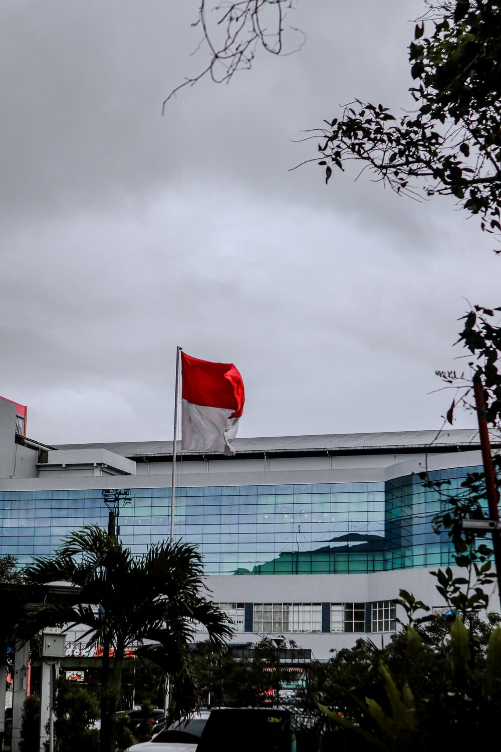 a large building with a red and white flag on top of it