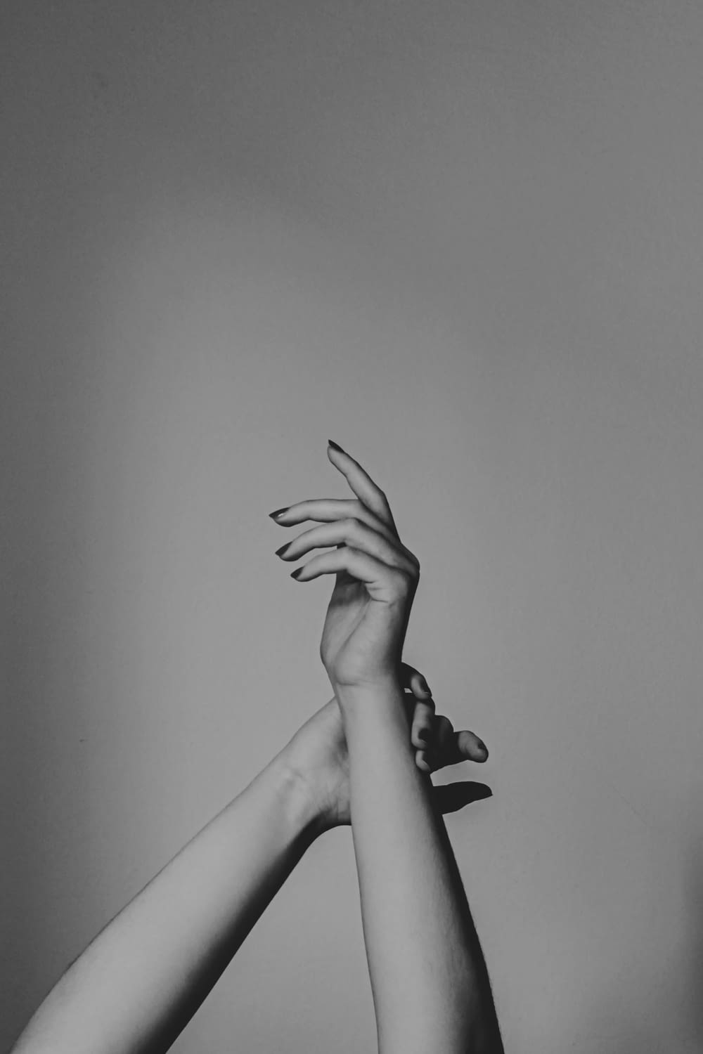 grayscale photo of woman with tattoo on her right hand