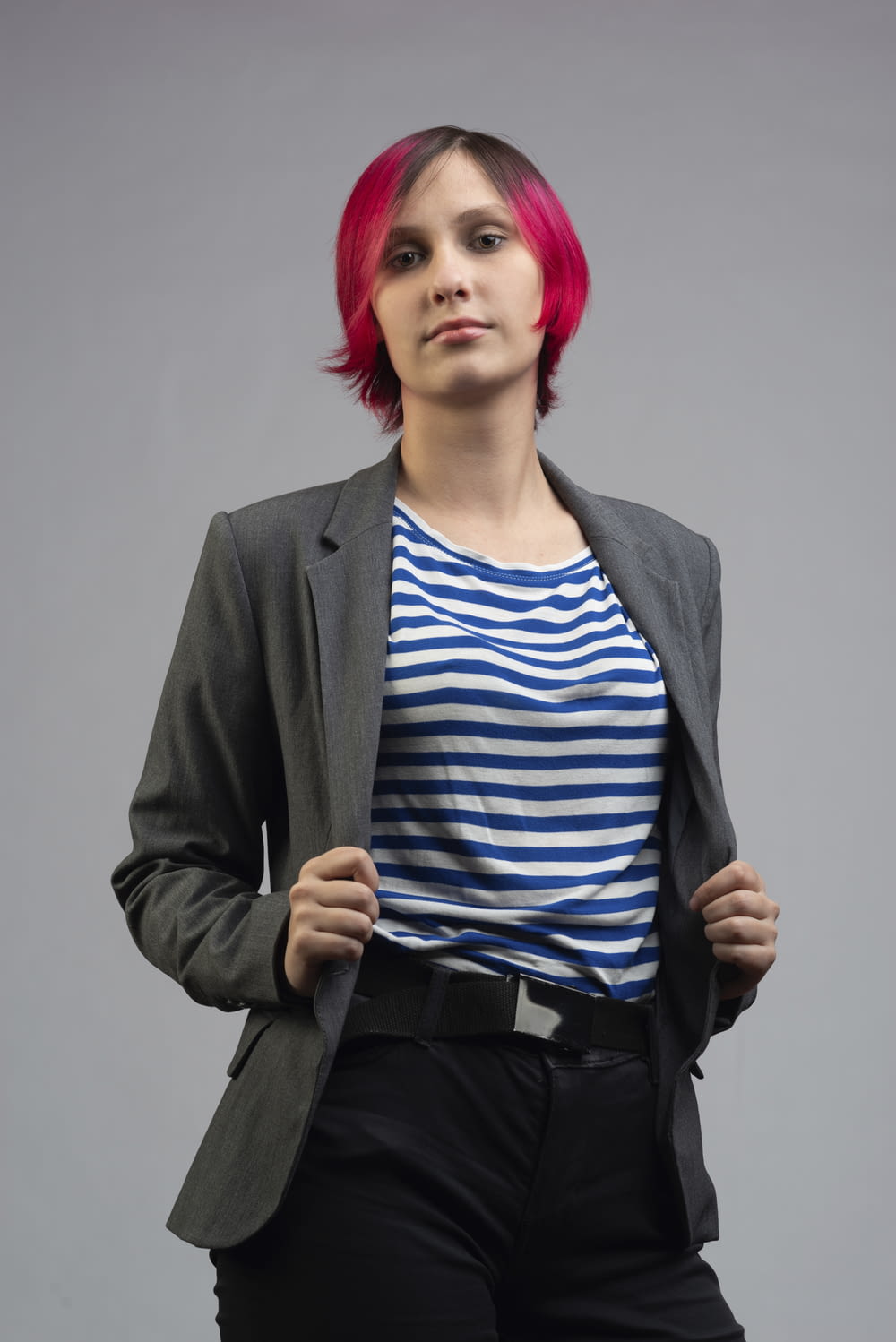 a woman with pink hair and a striped shirt