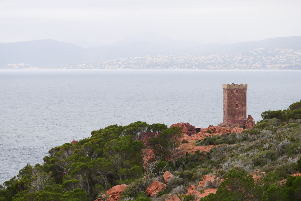 a tower on top of a hill near the ocean