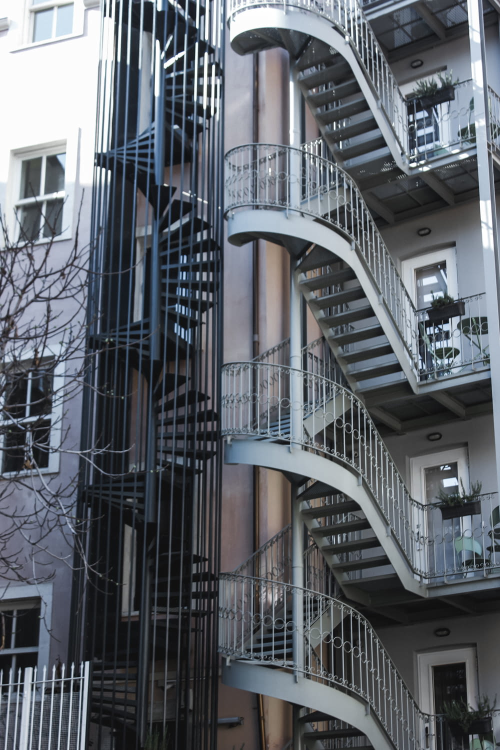 a spiral staircase in front of a tall building