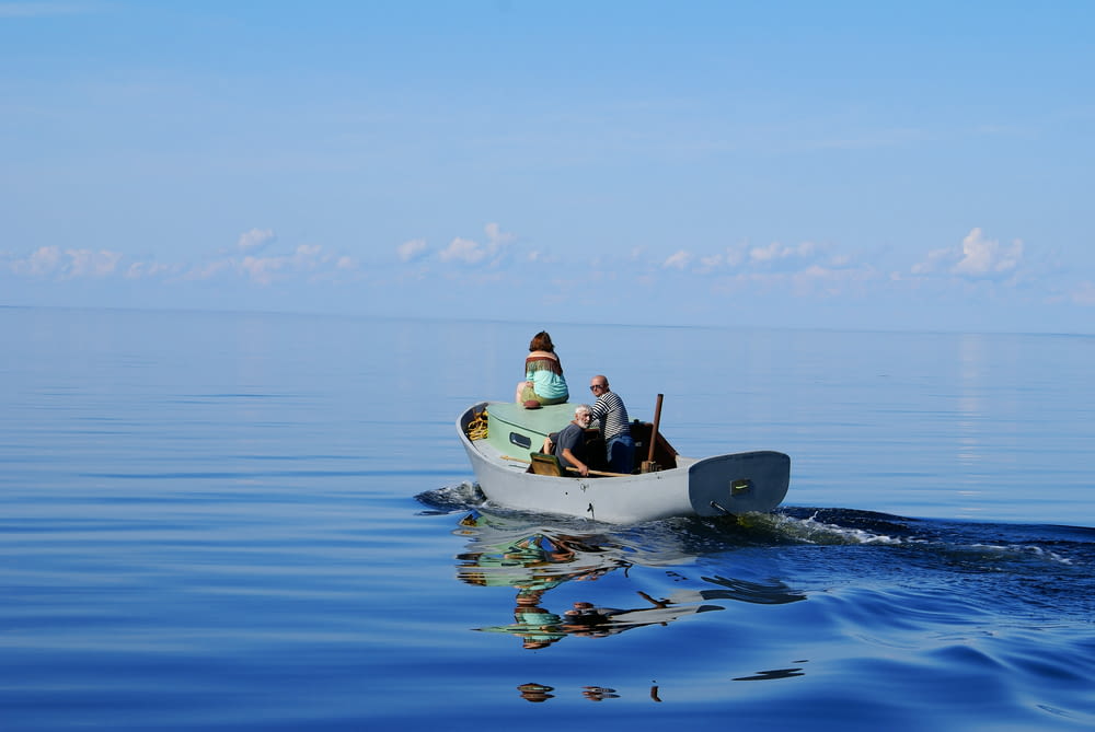2 person riding on yellow and black kayak on blue sea during daytime
