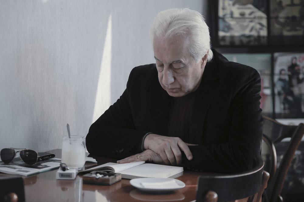 man in black sweater sitting at the table