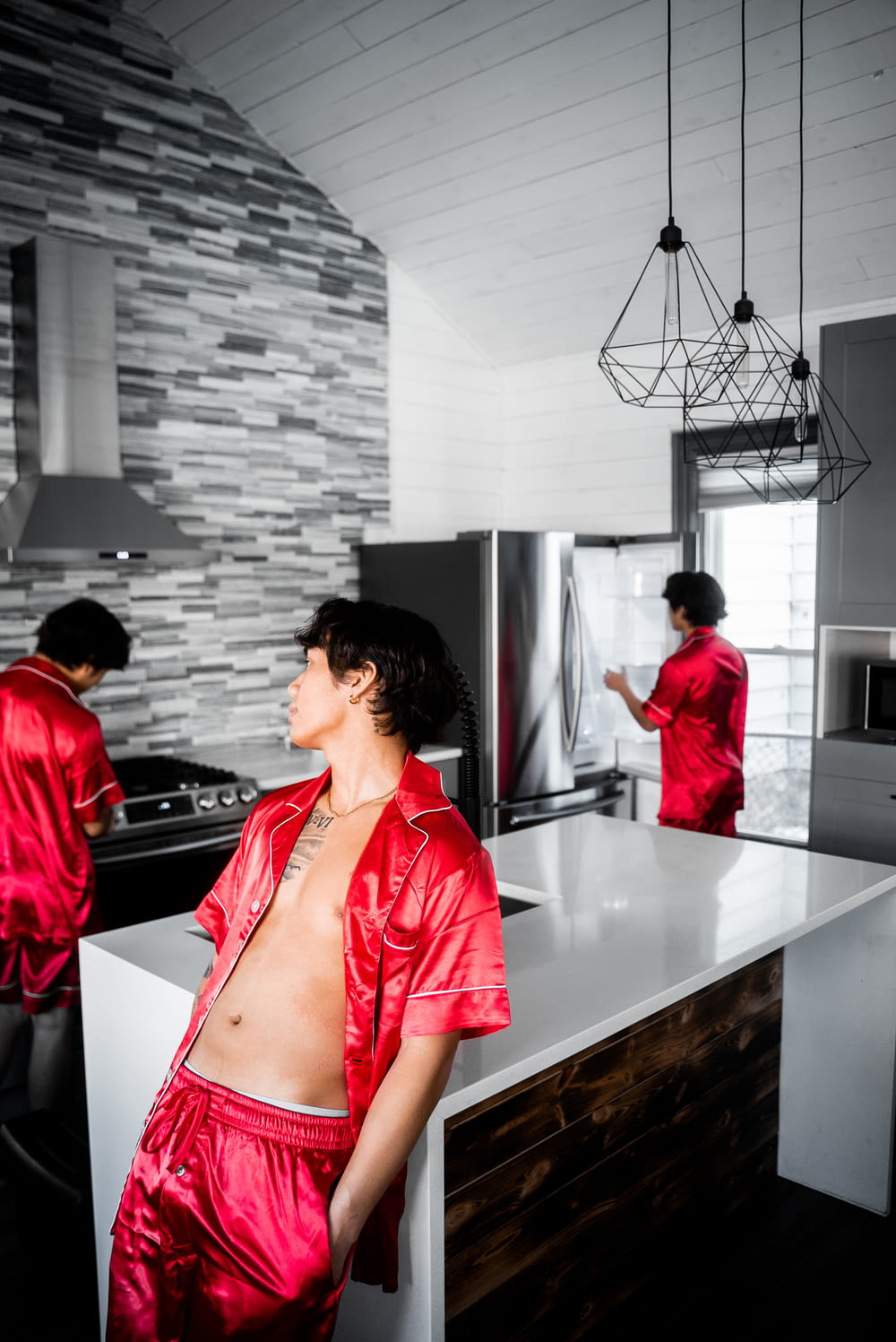 woman in red button up shirt standing beside counter