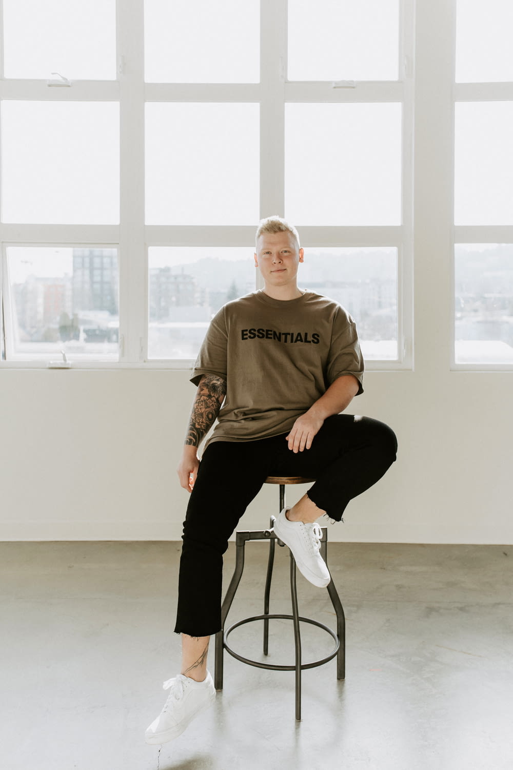 man in brown crew neck t-shirt sitting on black chair