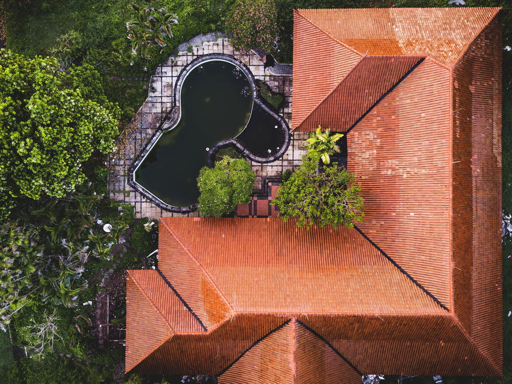aerial view of green trees and brown brick wall