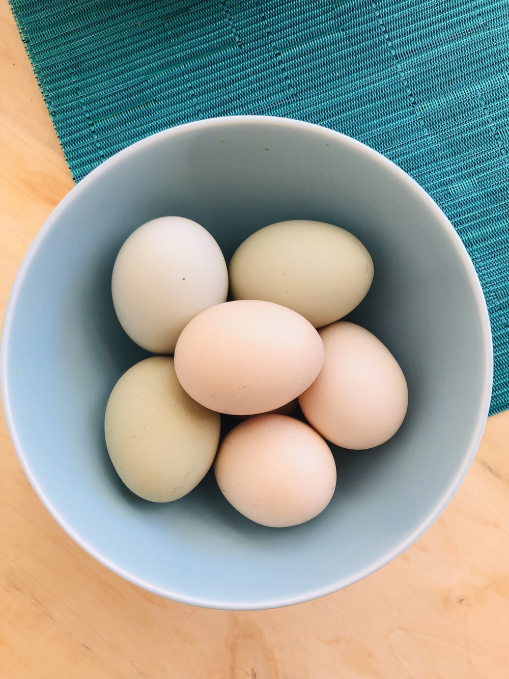 white eggs in blue ceramic bowl