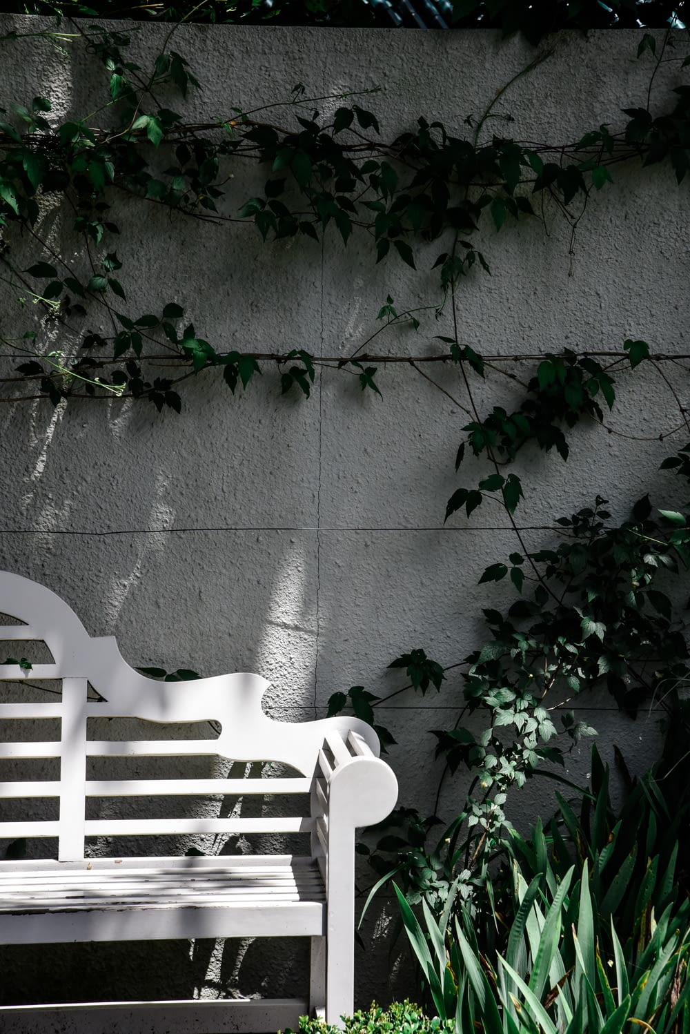 white plastic armchair beside gray concrete wall