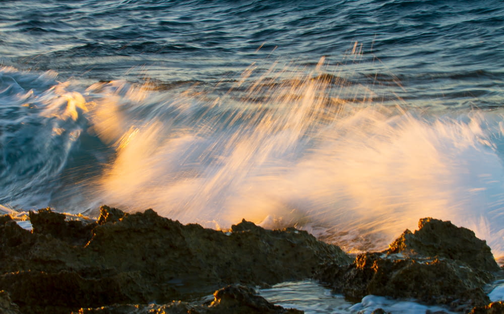 time lapse photography of water waves hitting rocks