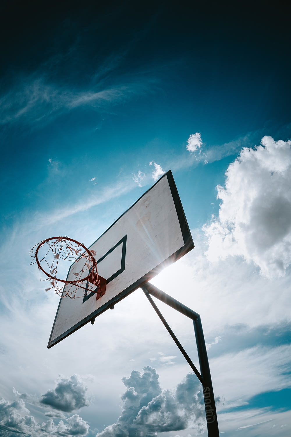 basketball hoop under blue sky during daytime