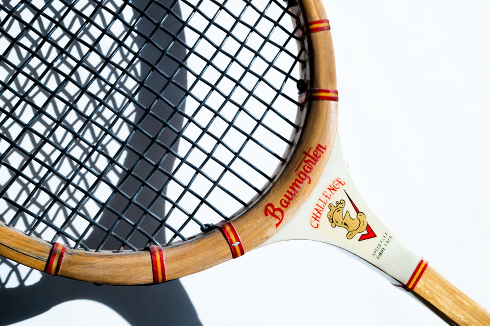 white and brown tennis racket