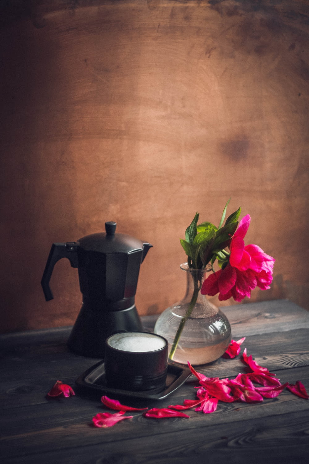 black and silver coffee pot beside black ceramic mug