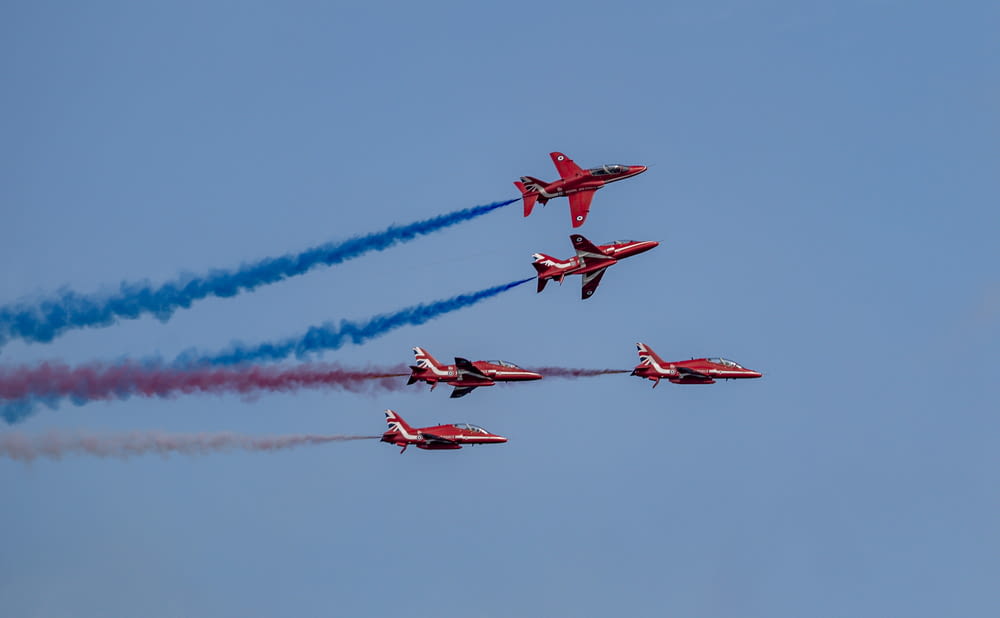 four red jet planes in mid air