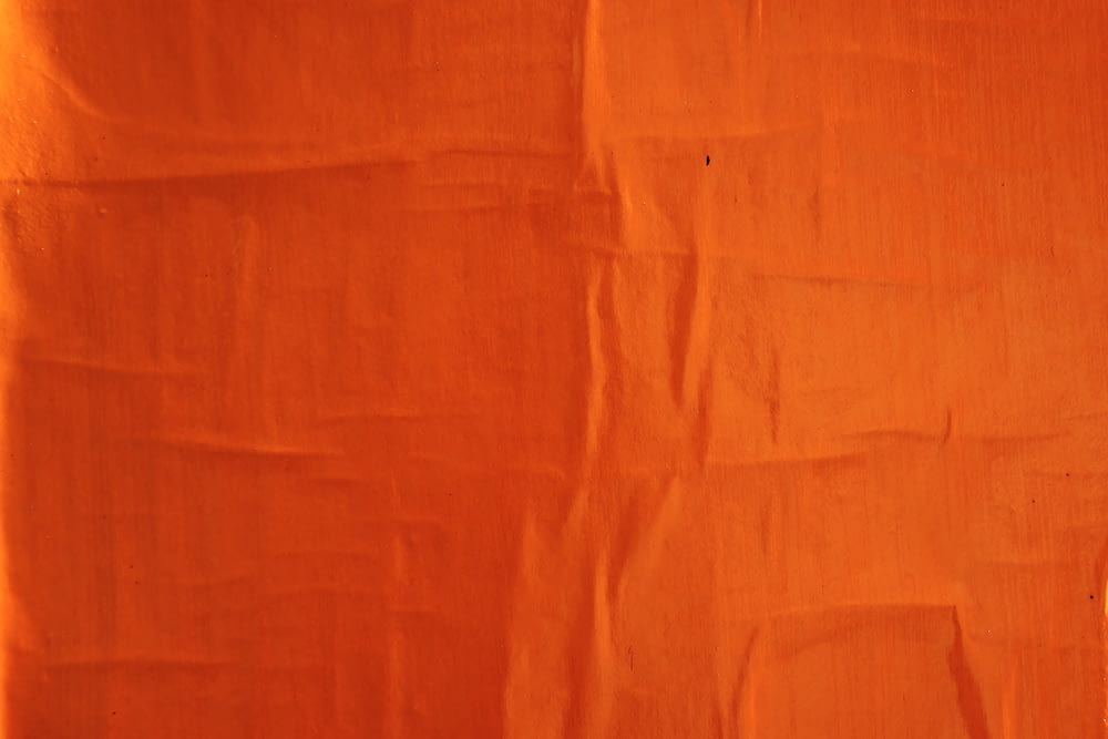 orange textile on white textile