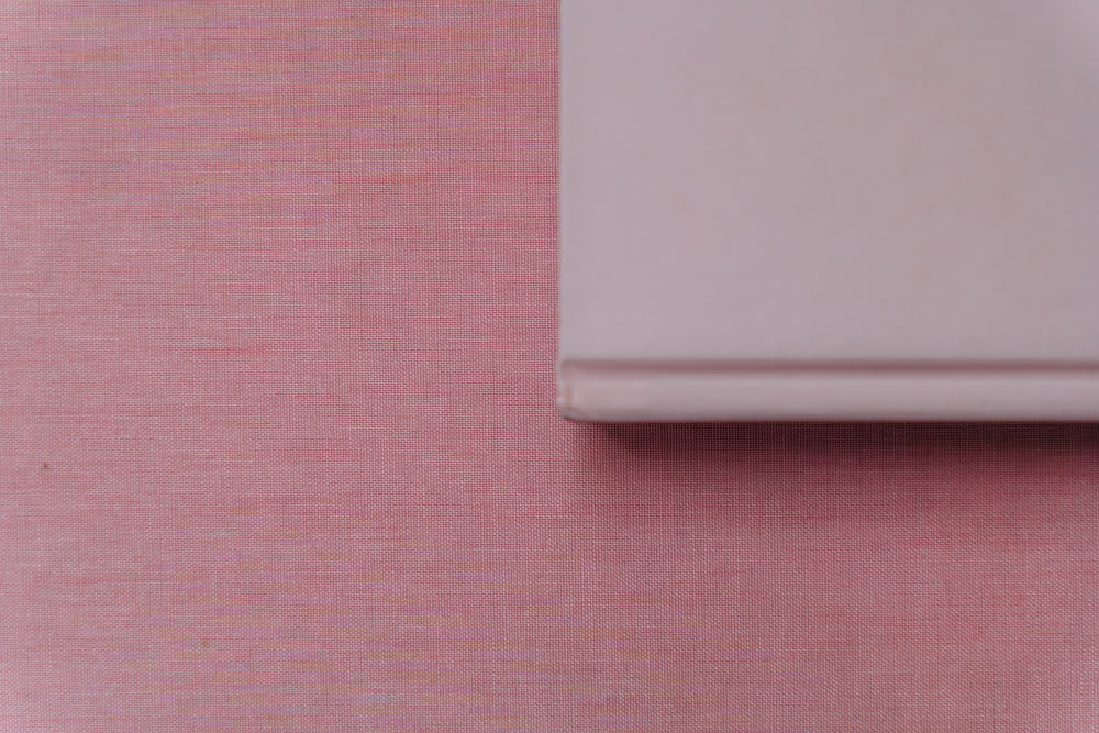 white device on pink textile