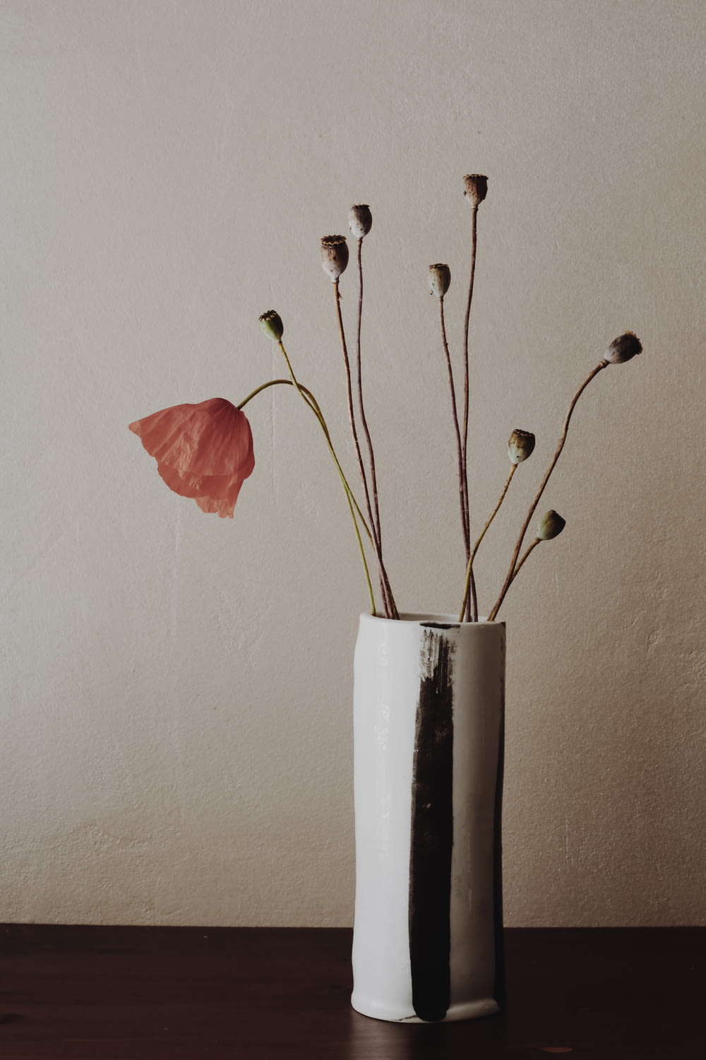 red flower in white ceramic vase