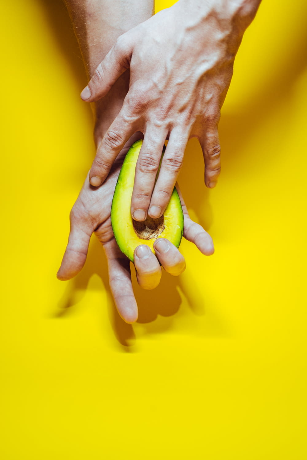 persons hand on yellow surface