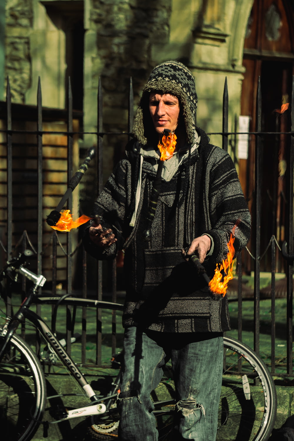 man in black jacket holding fire