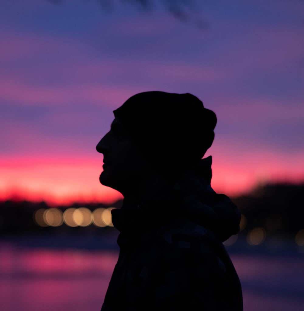 silhouette of man with hoodie during sunset
