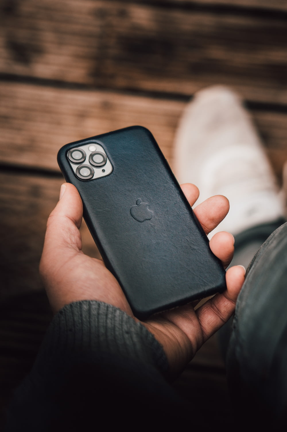 person holding black smartphone with black case