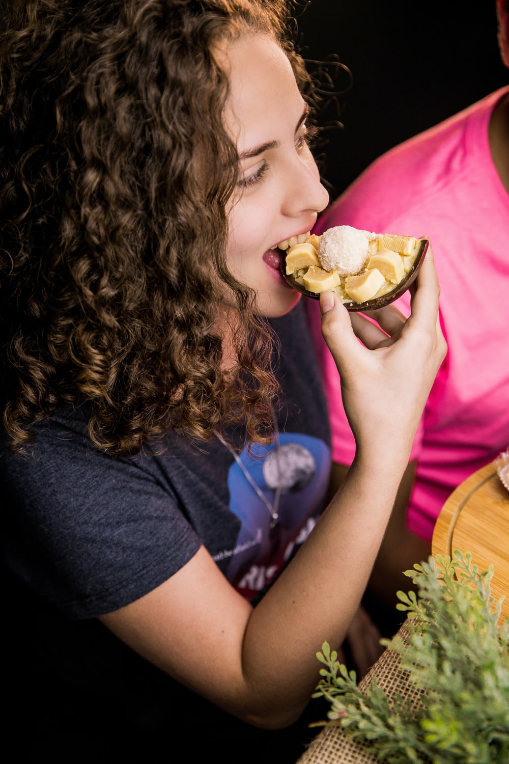 girl in black shirt eating burger