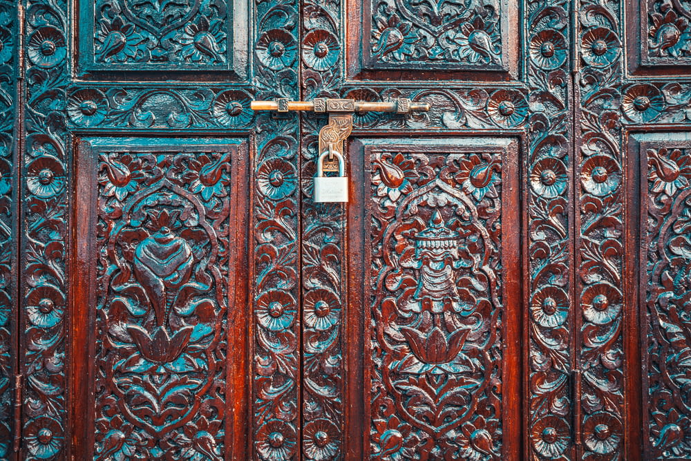 brown wooden door with padlock