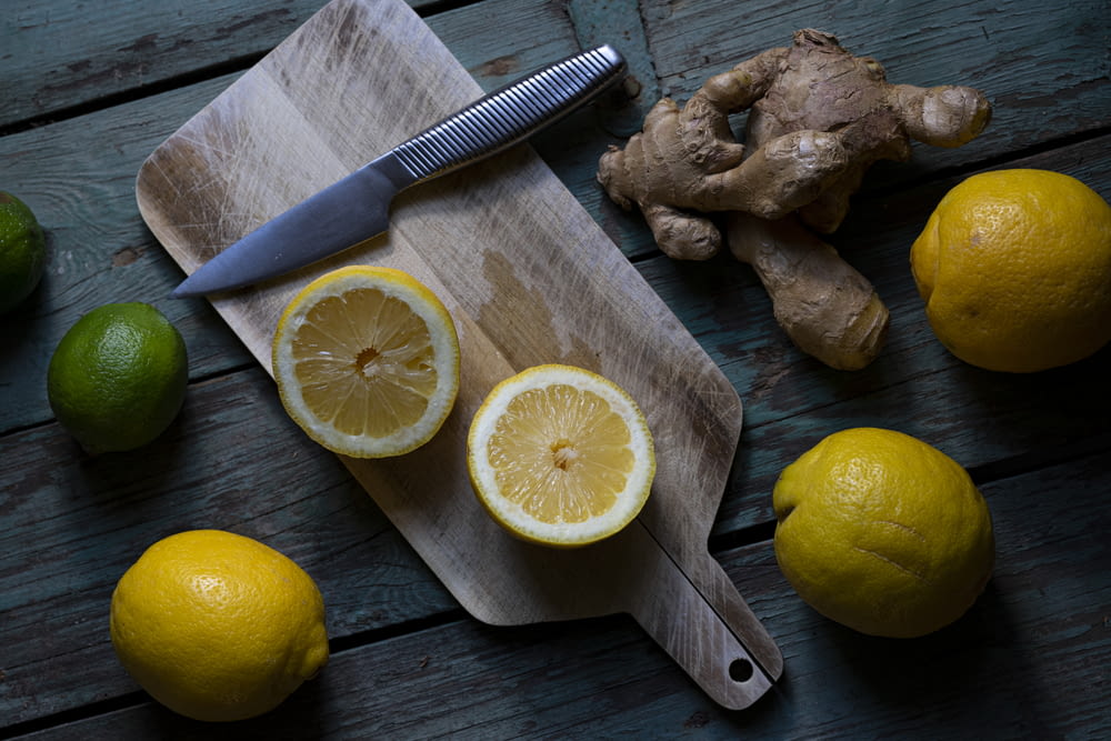 sliced lemon beside sliced lemon on chopping board