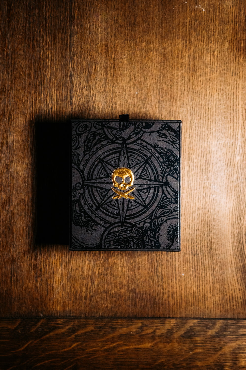 black and gold box on brown wooden table