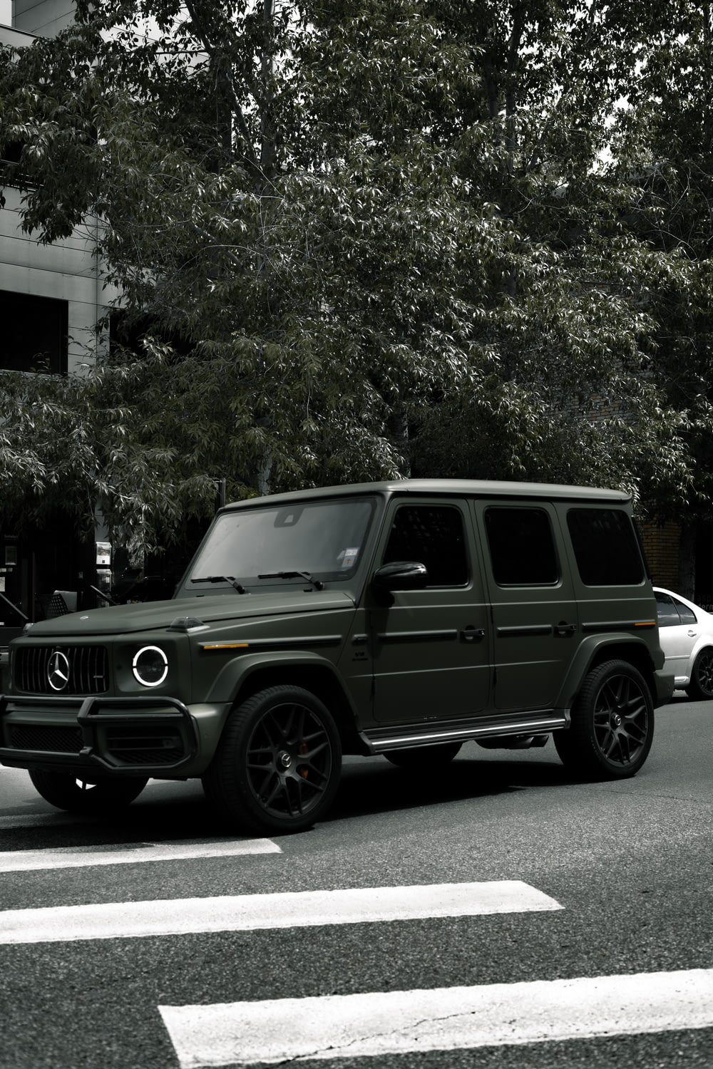 black jeep wrangler parked near green trees during daytime
