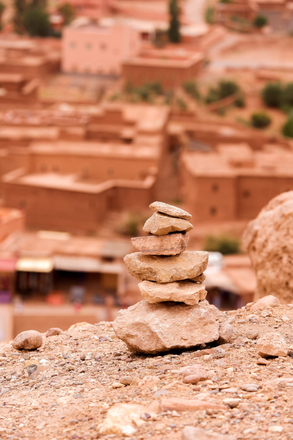 stack of stones on brown sand during daytime