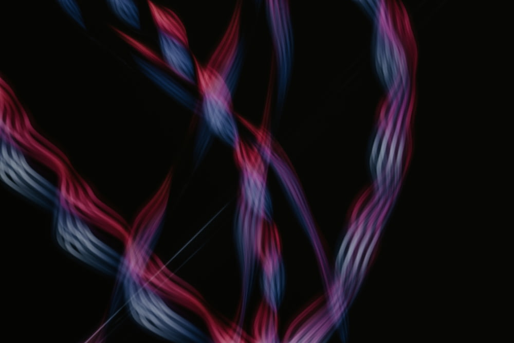 a red, white and blue swirl on a black background