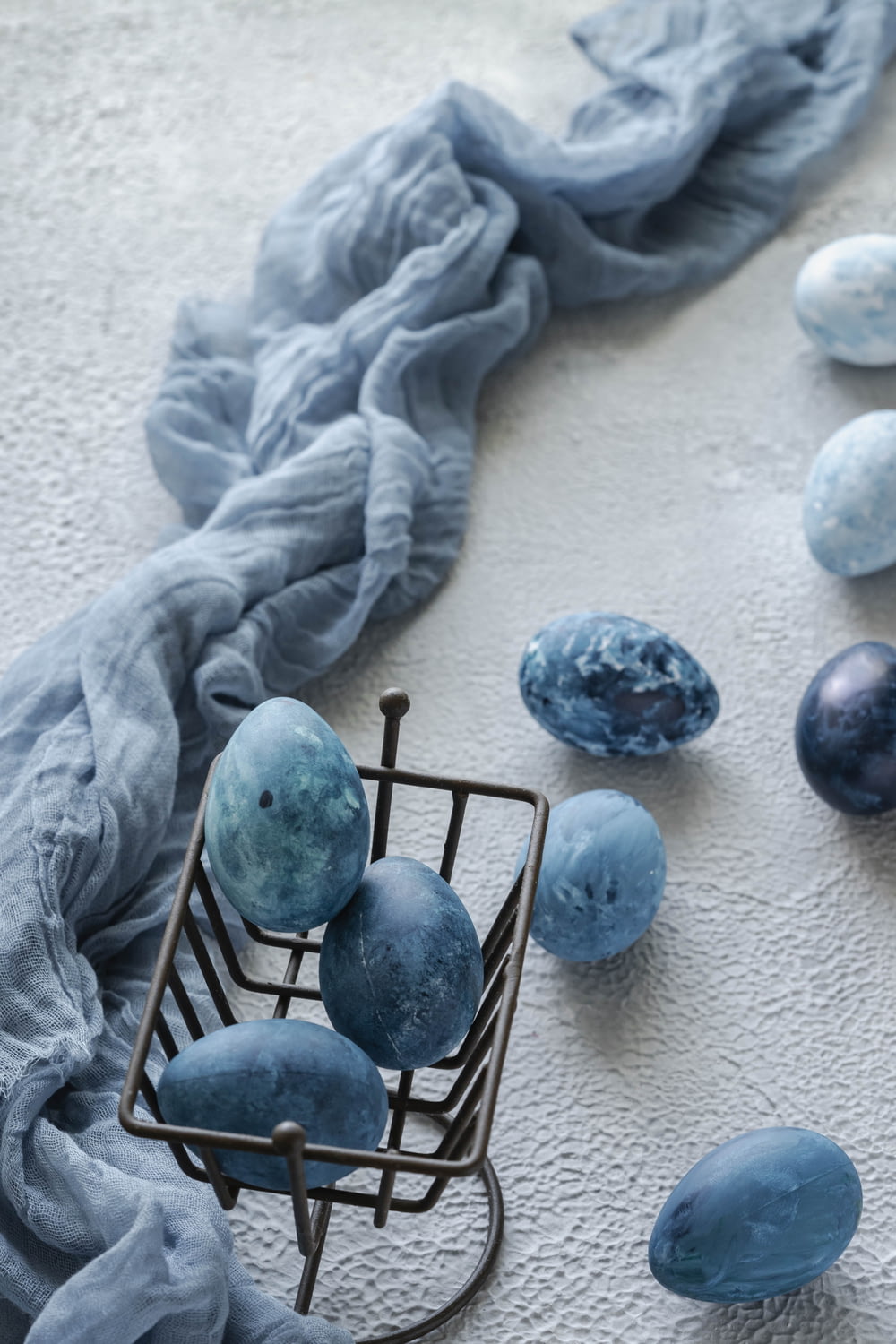 blue and white round ornament on white textile