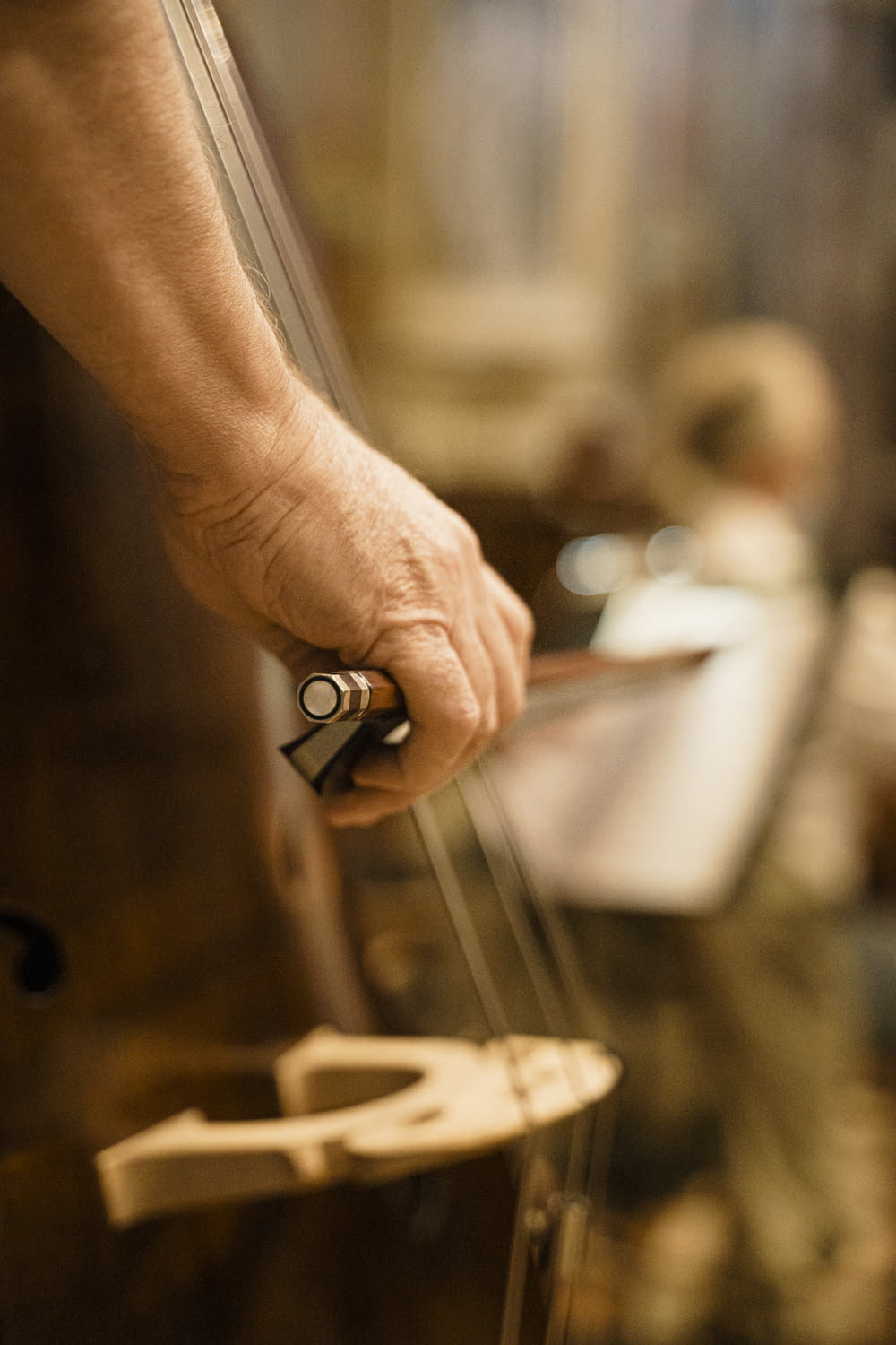 a person holding a violin string in their hand
