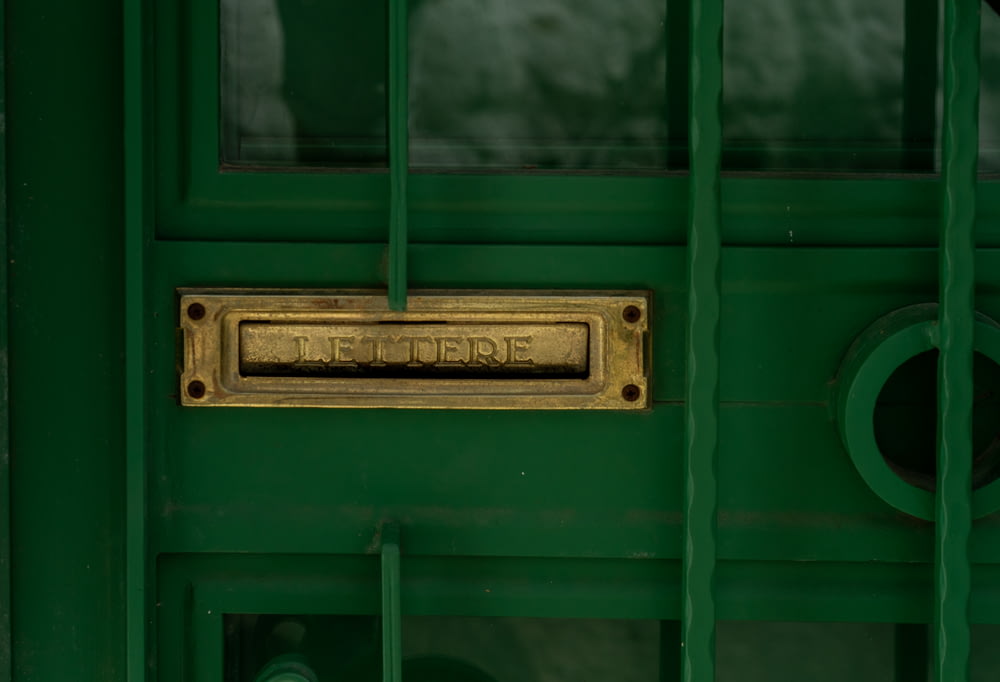green wooden door with silver door lever