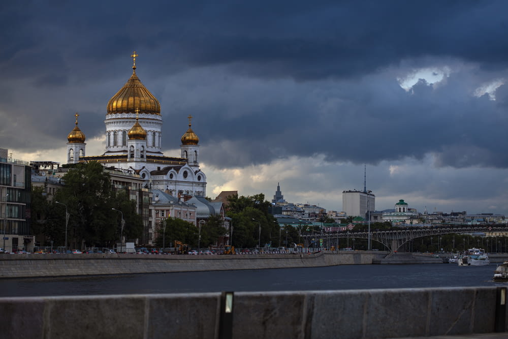 white and gold dome building under cloudy sky during daytime