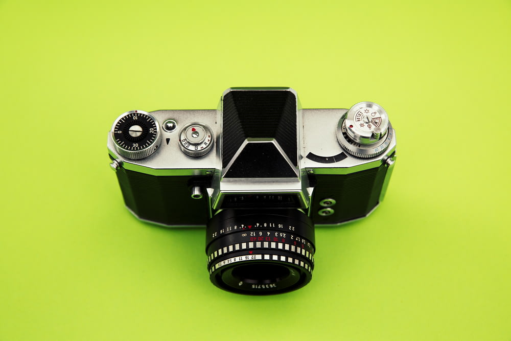 black and silver camera on green surface