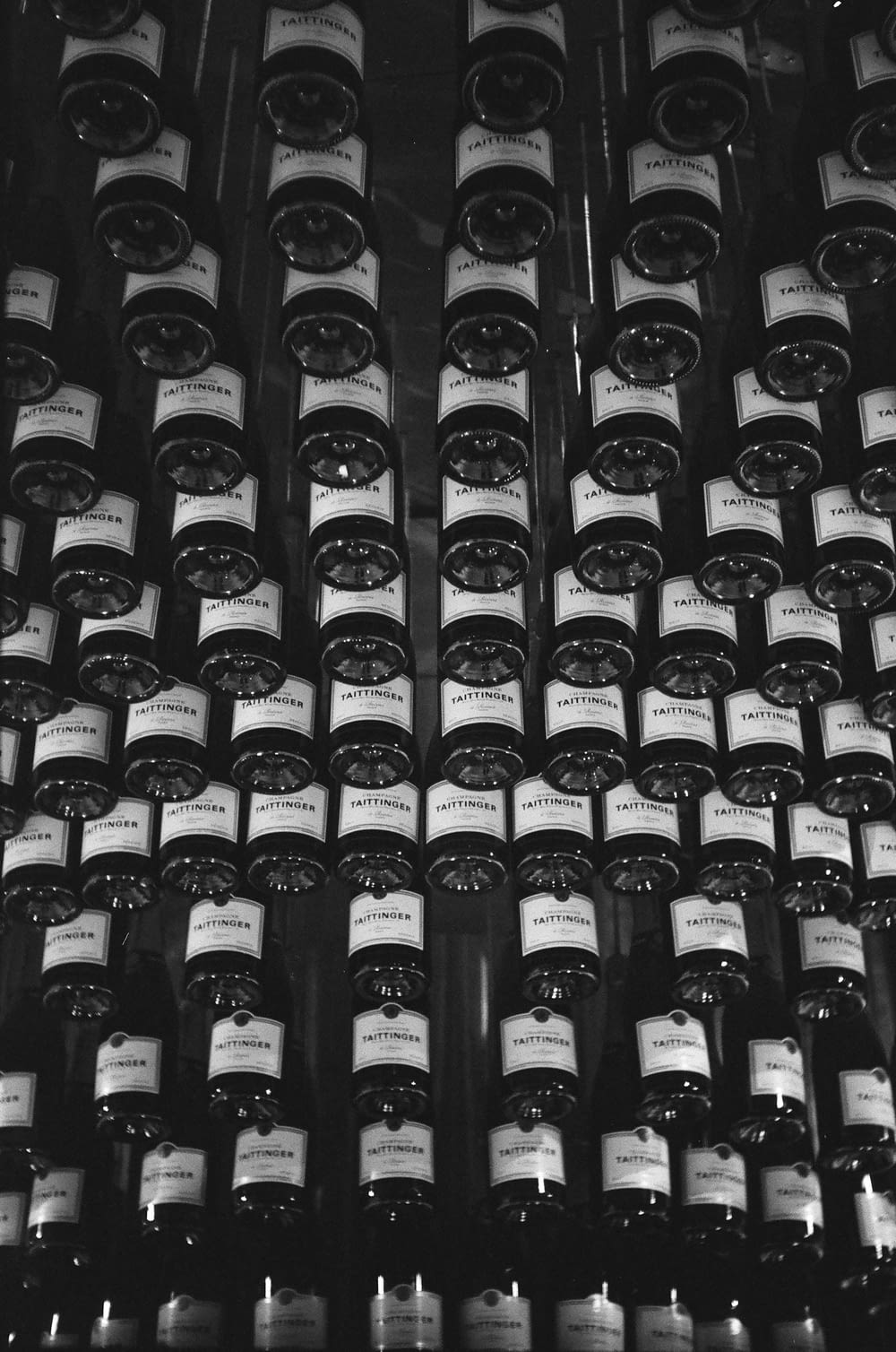 black glass bottles on brown wooden shelf