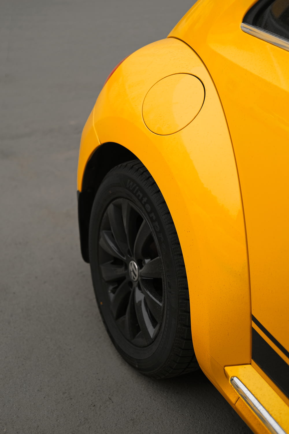yellow car on gray asphalt road