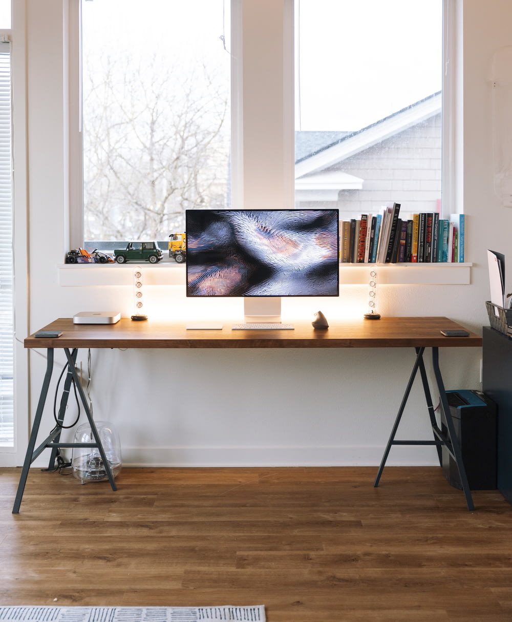 silver imac on brown wooden table