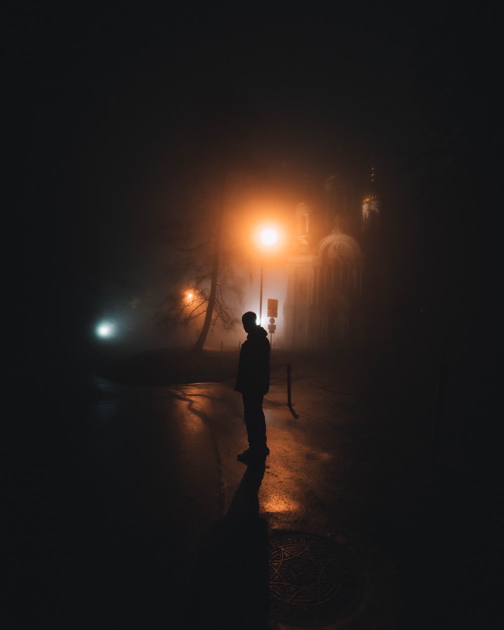 person standing on pathway during night time